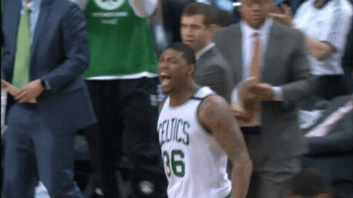 A Basketball Player Wearing A Celtics Jersey Is Screaming GIF