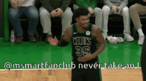 A Basketball Player Wearing A Celtics Jersey Is Standing On The Court GIF