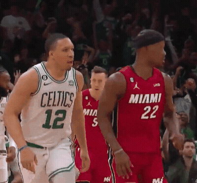 A Basketball Player Wearing A Celtics Jersey Stands Next To Another Player Wearing A Miami Jersey . GIF