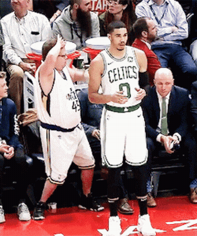 A Basketball Player Wearing A Celtics Jersey Stands On A Court GIF
