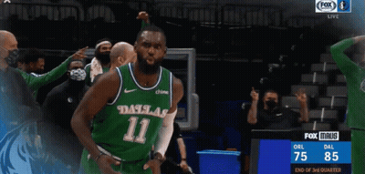 A Basketball Player Wearing A Dallas 11 Jersey Is Celebrating GIF