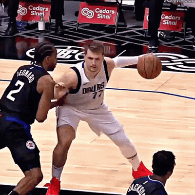 A Basketball Player Wearing A Dallas Jersey Is Dribbling The Ball GIF