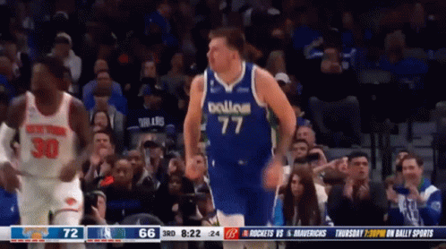 A Basketball Player Wearing A Dallas Jersey Is Running On The Court GIF