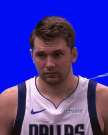 A Basketball Player Wearing A Dallas Jersey With A Blue Background GIF