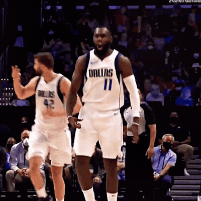 A Basketball Player Wearing A Dallas Uniform Is Standing On The Court GIF