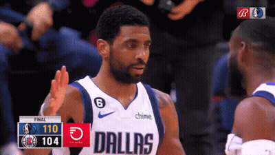 A Basketball Player Wearing A Dallas Uniform Talks To Another Player GIF