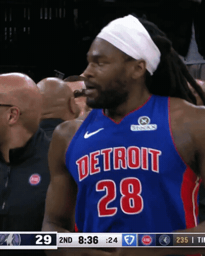 A Basketball Player Wearing A Detroit 28 Jersey Is Eating Something GIF