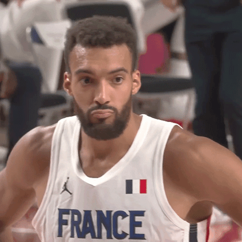 A Basketball Player Wearing A France Jersey Looks To The Side GIF