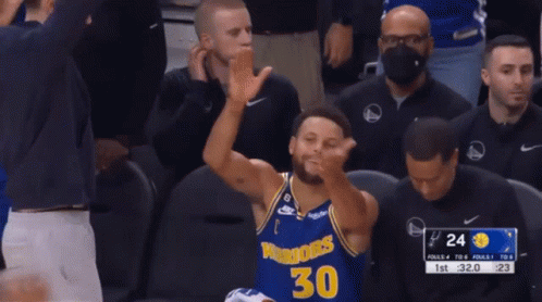 A Basketball Player Wearing A Golden State Warriors Jersey Is Clapping His Hands GIF