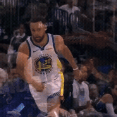 A Basketball Player Wearing A Golden State Warriors Jersey Is Dribbling The Ball GIF