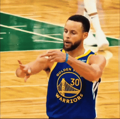 A Basketball Player Wearing A Golden State Warriors Jersey Is Making A Gesture With His Hands . GIF