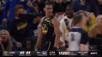 A Basketball Player Wearing A Golden State Warriors Jersey Stands In Front Of A Crowd . GIF