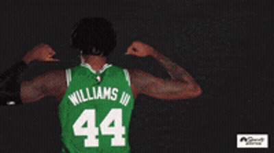 A Basketball Player Wearing A Green Boston Jersey GIF