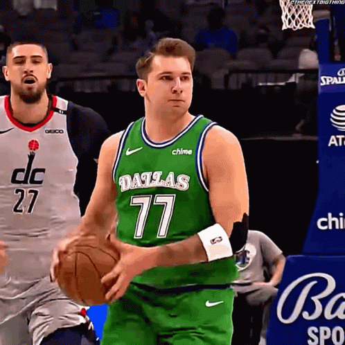 A Basketball Player Wearing A Green Dallas Jersey Is Holding A Basketball GIF