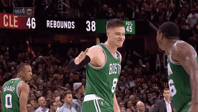 A Basketball Player Wearing A Green Jersey That Says Boston Is Giving Another Player A High Five GIF
