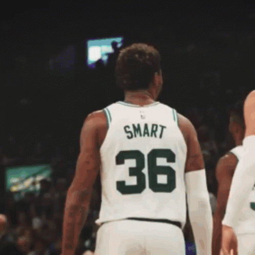 A Basketball Player Wearing A Green Jersey With Boston On It GIF