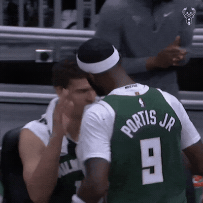 A Basketball Player Wearing A Green Jersey With The Number 9 On The Back GIF