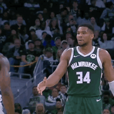 A Basketball Player Wearing A Green Milwaukee Jersey GIF