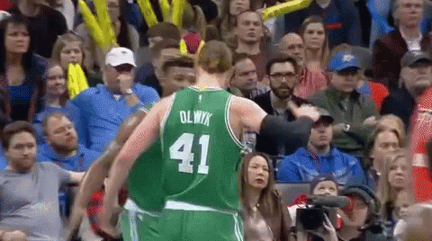 A Basketball Player Wearing A Green Uniform With The Number 41 On It GIF