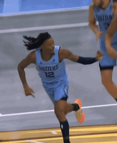A Basketball Player Wearing A Grizzlies Jersey Is Running On A Court GIF