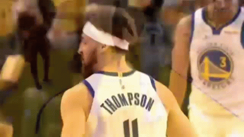 A Basketball Player Wearing A Headband And A Number 11 Jersey Is Standing In Front Of A Crowd . GIF