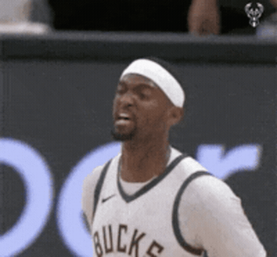 A Basketball Player Wearing A Headband And A White Jersey With The Word Buck On It GIF