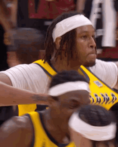 A Basketball Player Wearing A Headband And A Yellow Jersey GIF