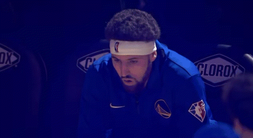 A Basketball Player Wearing A Headband Is Sitting In The Stands With His Mouth Open . GIF