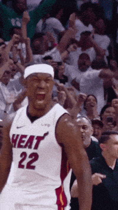 A Basketball Player Wearing A Heat 22 Jersey Is Standing In Front Of A Crowd GIF