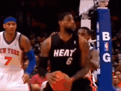 A Basketball Player Wearing A Heat Jersey Is Holding A Basketball While Playing Basketball . GIF