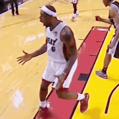 A Basketball Player Wearing A Heat Jersey Is Jumping On The Court GIF