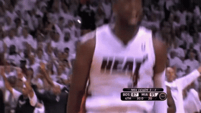 A Basketball Player Wearing A Heat Jersey Is Standing In Front Of A Crowd GIF