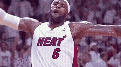 A Basketball Player Wearing A Heat Jersey With His Arms Outstretched GIF