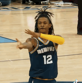 A Basketball Player Wearing A Jersey That Says Memphis 12 GIF