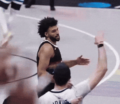 A Basketball Player Wearing A Jersey That Says Oklahoma Is Hugging Another Player GIF