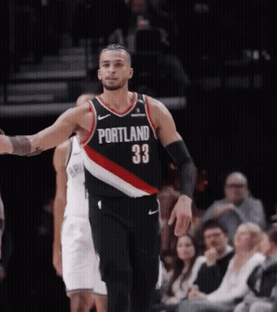 A Basketball Player Wearing A Jersey That Says Portland On It GIF