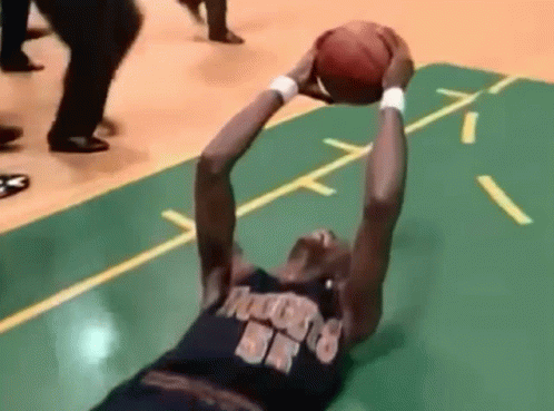 A Basketball Player Wearing A Jersey That Says Rockets On It Is Reaching For The Ball GIF