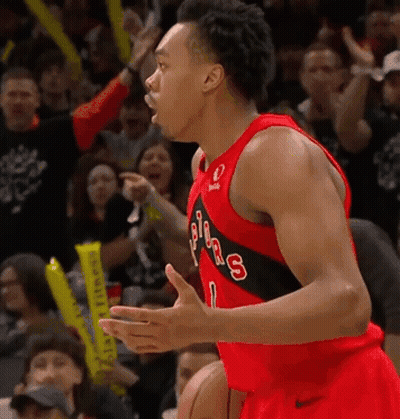 A Basketball Player Wearing A Jersey That Says Toronto Raptors GIF