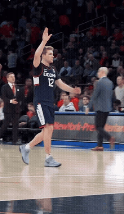 A Basketball Player Wearing A Jersey That Says Uconn GIF