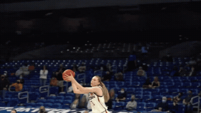 A Basketball Player Wearing A Jersey That Says Uconn On It GIF