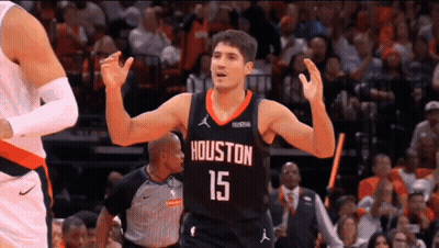 A Basketball Player Wearing A Jersey With The Number 15 On It Is Celebrating During A Game . GIF