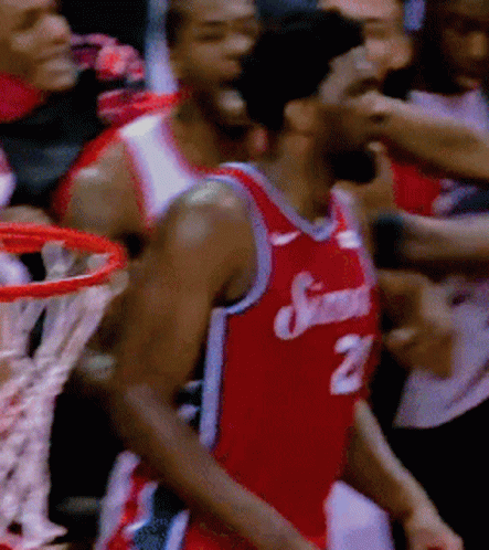 A Basketball Player Wearing A Jersey With The Number 21 On It GIF