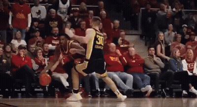 A Basketball Player Wearing A Jersey With The Number 30 On It Is Dribbling A Basketball In Front Of A Crowd Of People . GIF