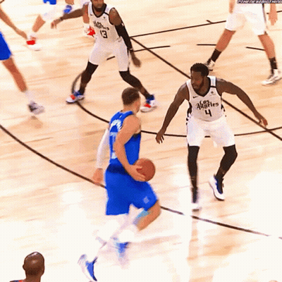 A Basketball Player Wearing A Jersey With The Number 4 On It Dribbles The Ball GIF