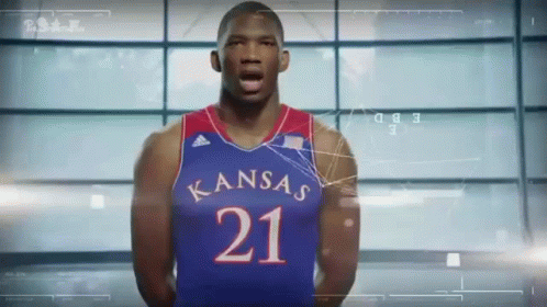 A Basketball Player Wearing A Kansas Jersey With The Number 21 On It GIF