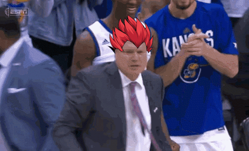 A Basketball Player Wearing A Kansas Shirt Applauds A Coach GIF