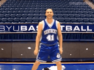A Basketball Player Wearing A Kentucky Jersey Number 41 Stands In Front Of An Empty Stadium GIF