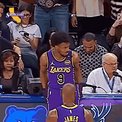 A Basketball Player Wearing A Lakers Jersey Stands In Front Of A Crowd GIF