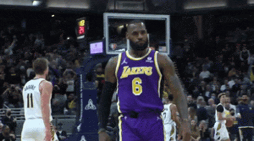 A Basketball Player Wearing A Lakers Jersey Stands On The Court GIF