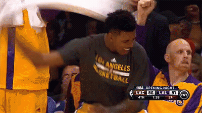A Basketball Player Wearing A Los Angeles Basketball Shirt Is Being Congratulated By His Teammates GIF